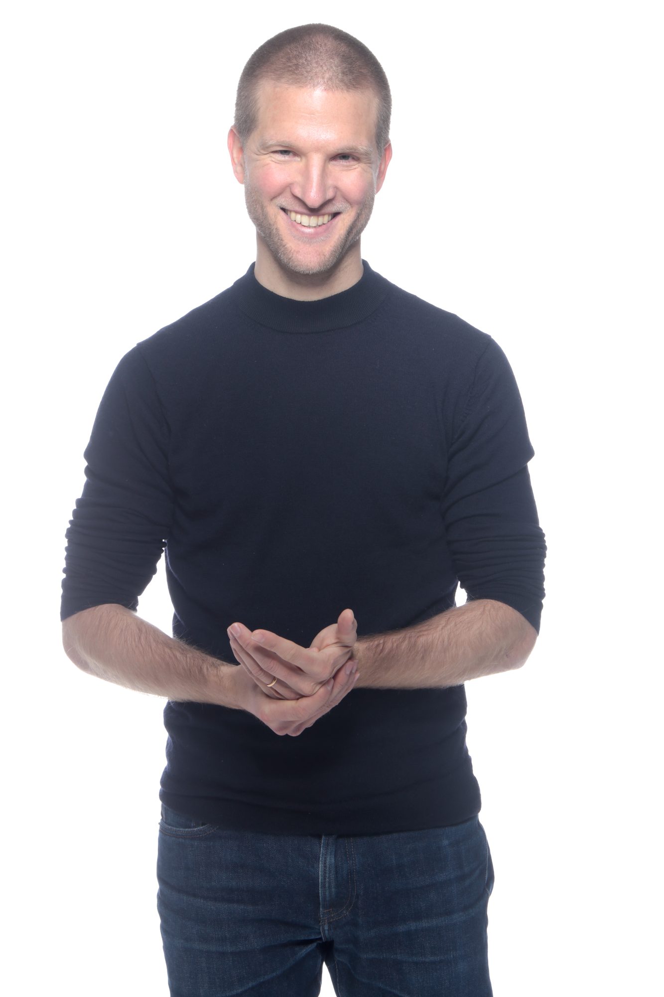 Portrait studio, mains jointes, pull noir et jean